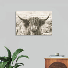  “You Have My Attention” by Nathan Larson is a mesmerizing canvas print that beckons viewers into a serene world of contemplation. The intricate black and white portrait captures the soulful gaze of a majestic highland cow, its long, wavy hair cascading over expressive eyes and formidable horns. Larson’s attention to detail brings every strand of the cow’s iconic fur to life, evoking a sense of timelessness.