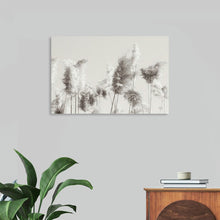  In the Wind II by Nathan Larson is a serene and minimalist black and white photograph that captures the delicate beauty of tall grasses swaying in the breeze. The soft, feathery plumes of the grasses create a sense of lightness and tranquility, while the stark contrast between the dark stems and the light background adds a touch of drama. This print is a perfect choice for those seeking a calming and minimalist addition to their home.