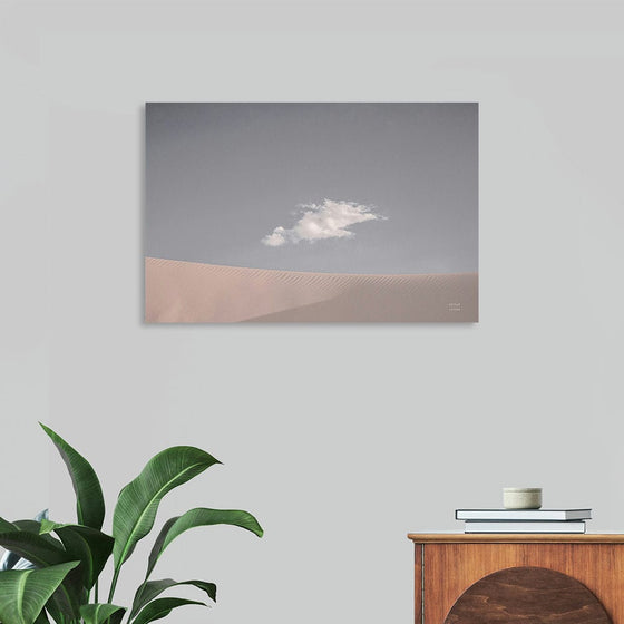 “White Sands Neutral” by Nathan Larson invites you into a world of serene elegance. This exquisite print captures the ethereal dance of a solitary cloud hovering above the pristine, undulating sands of a tranquil desert. The artwork’s minimalist aesthetic, characterized by its soft color palette and expansive composition, invites a sense of calm and introspection. 