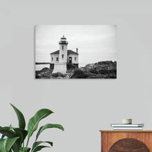  Nathan Larson's "Looking Out" captures the timeless allure of a solitary lighthouse standing tall against a dramatic, cloudy sky. The black and white tones enhance the lighthouse's stark beauty and the ruggedness of its coastal setting. The image evokes a sense of tranquility and resilience, inviting viewers to contemplate the enduring power of nature and the guiding light of hope.