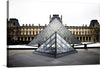 Immerse yourself in the architectural splendor of the iconic Louvre Pyramid with this exquisite print. The artwork captures a serene moment at the world-renowned Louvre Museum, where modern design meets historical grandeur. The glass pyramid, a masterpiece of contemporary architecture, stands majestically against the backdrop of the ornate Renaissance-style palace. 