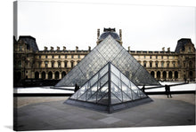  Immerse yourself in the architectural splendor of the iconic Louvre Pyramid with this exquisite print. The artwork captures a serene moment at the world-renowned Louvre Museum, where modern design meets historical grandeur. The glass pyramid, a masterpiece of contemporary architecture, stands majestically against the backdrop of the ornate Renaissance-style palace. 