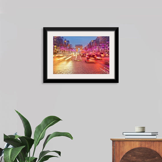 "Night view of Arc de Triomphe with vehicle light trails effect"