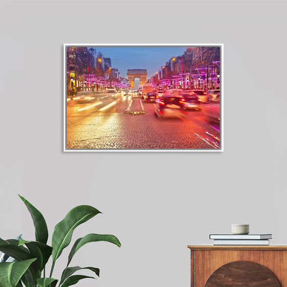 "Night view of Arc de Triomphe with vehicle light trails effect"