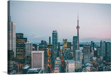  This artwork captures the mesmerizing allure of a cityscape at dusk. The towering architectural marvels kissed by the setting sun, and the iconic skyline punctuated by illuminated windows create a symphony of light and shadow. The prominent CN Tower stands amidst the buildings, its spire piercing into the soft hues of twilight. This print is not just a visual spectacle but an experience, inviting viewers into a world where modernity and elegance coexist seamlessly.