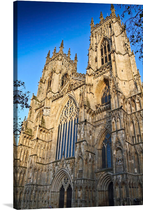 “York Minster” by Michael D Beckwith invites you to a world of architectural grandeur and celestial light. This exquisite print captures the iconic Gothic cathedral bathed in soft, golden hues—the sun illuminating its majestic façade and intricate details. Every stone and stained glass window tells a story of history, artistry, and spirituality. 