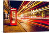 This stunning print captures the vibrant energy of a city that never sleeps, with a focus on a traditional British red telephone booth. The booth stands as a sentinel of tradition amidst the dynamic blur of lights, showcasing London’s unique blend of history and modernity. The streaks of light tell a story of motion and progress, while the silent, steadfast booth whispers tales of bygone eras. 