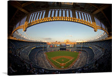  “A View of Yankee Stadium” at sunset is a symphony of patriotism and sporting grandeur. As the sun dips below the horizon, it bathes the iconic stadium in a warm, golden glow. The meticulously manicured field awaits the clash of titans, while the stands hum with anticipation. But it’s the celestial performance above that steals the show—the F-16C Fighting Falcons streak across the sky, their contrails echoing the fervor of the National Anthem. 
