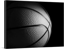  This stunning black and white photograph of a basketball captures the beauty and power of the game. The basketball is shown in all its spherical glory, with its perfectly symmetrical panels and intricate stitching. The black and white background creates a sense of drama and mystery, making the basketball the focal point of the image.