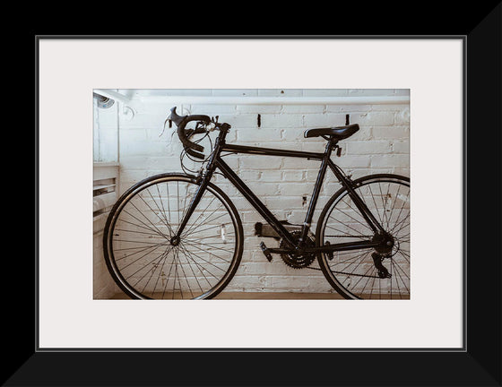 "Black Bicycle Against a White Wall"