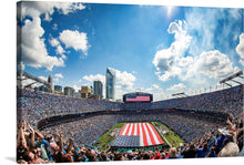  “Carolina Panthers’ Military Appreciation football game” is a beautiful print that captures the excitement and energy of the event. The image showcases the American flag being unfurled on the field, the packed stadium, and the beautiful skyline. 