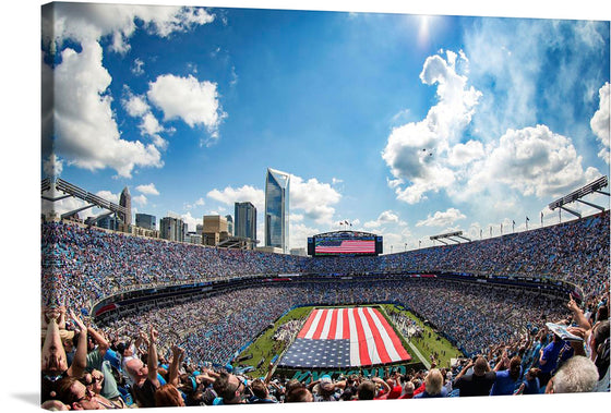 “Carolina Panthers’ Military Appreciation football game” is a beautiful print that captures the excitement and energy of the event. The image showcases the American flag being unfurled on the field, the packed stadium, and the beautiful skyline. 