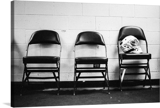 Evoke the camaraderie and dedication of our armed forces with this powerful photo capturing a soldier's hockey helmet resting on a chair outside a locker room during the 5th Annual Army vs. Air Force Hockey Game in Anchorage, Alaska. The poignant image tells a story of both athleticism and service, combining the resilience of our military personnel with the shared passion for the game.