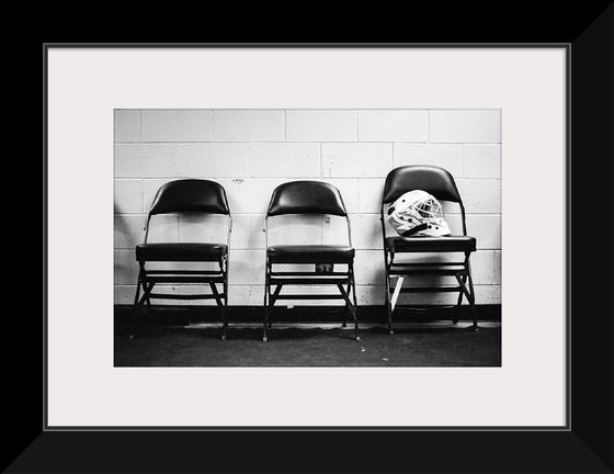"A soldier’s helmet rests on a chair"