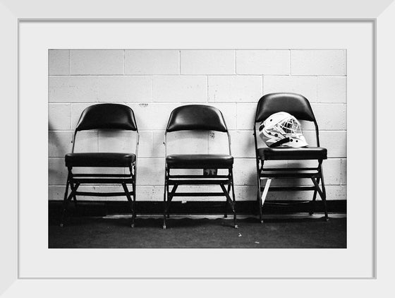 "A soldier’s helmet rests on a chair"