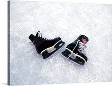  This captivating print, titled “Hockey Skates on Ice,” beautifully encapsulates a winter’s day on the ice. The focal point is a pair of abandoned hockey skates, their black bodies adorned with touches of red and white, resting upon the frosty surface. The skates, left behind on the ice marked by previous activity, evoke a sense of solitude and nostalgia.