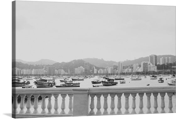 Immerse yourself in the serene elegance of this exquisite print capturing a timeless scene of a tranquil harbor. Boats, both small and large, float peacefully on the calm waters, painting a picture of harmony and quietude. The cityscape in the background stands as a silent witness to the dance between nature and civilization.