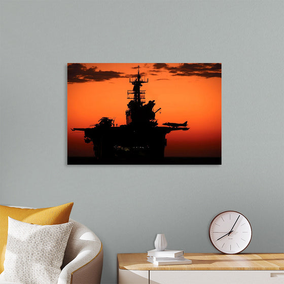 "The setting sun silhouettes the amphibious assault ship USS Makin Island", Gunnery Sgt. Scott Dunn