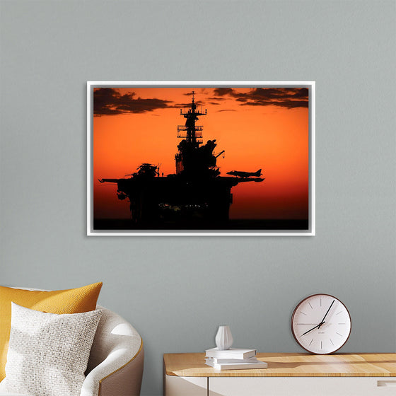 "The setting sun silhouettes the amphibious assault ship USS Makin Island", Gunnery Sgt. Scott Dunn