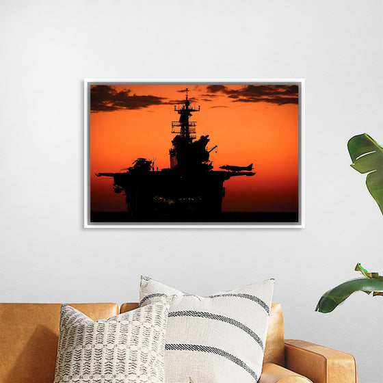 "The setting sun silhouettes the amphibious assault ship USS Makin Island", Gunnery Sgt. Scott Dunn