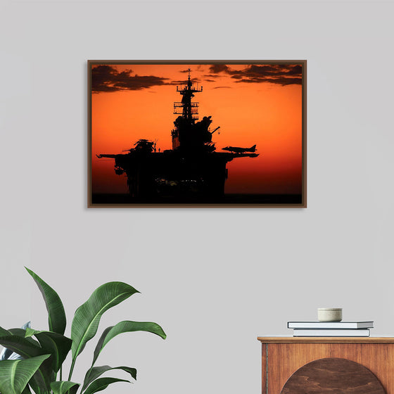 "The setting sun silhouettes the amphibious assault ship USS Makin Island", Gunnery Sgt. Scott Dunn