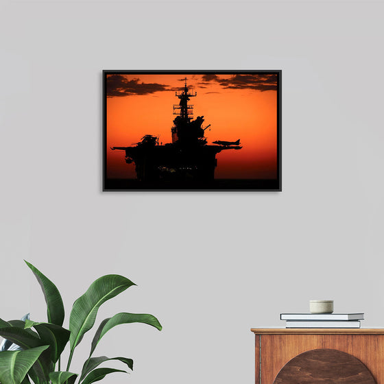 "The setting sun silhouettes the amphibious assault ship USS Makin Island", Gunnery Sgt. Scott Dunn