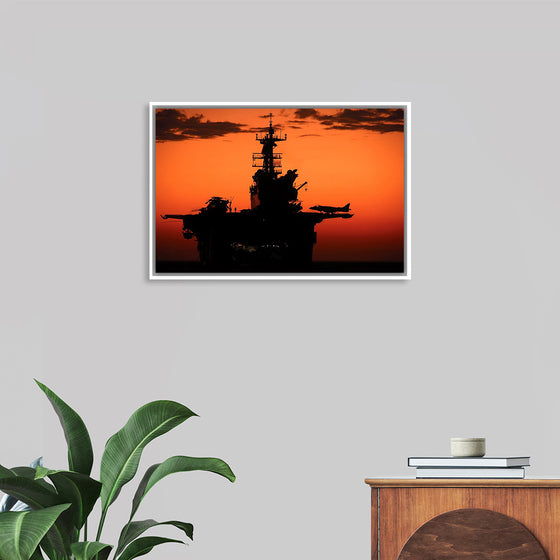 "The setting sun silhouettes the amphibious assault ship USS Makin Island", Gunnery Sgt. Scott Dunn