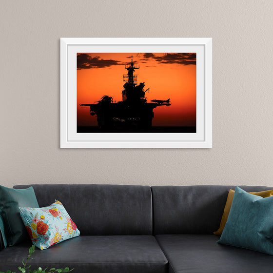 "The setting sun silhouettes the amphibious assault ship USS Makin Island", Gunnery Sgt. Scott Dunn