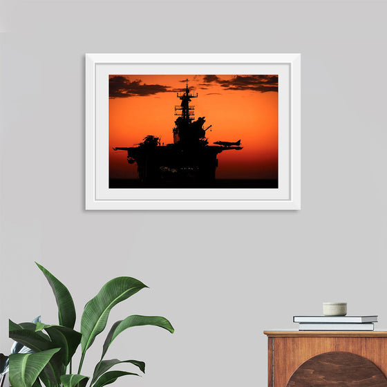 "The setting sun silhouettes the amphibious assault ship USS Makin Island", Gunnery Sgt. Scott Dunn