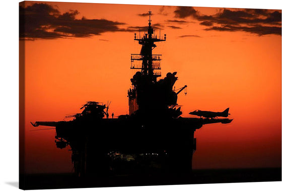 Immerse yourself in the captivating allure of this stunning print, capturing a majestic aircraft carrier silhouetted against the warm hues of a setting sun. Every intricate detail, from the towering command center to the poised aircraft ready for flight, is rendered with exquisite clarity. 