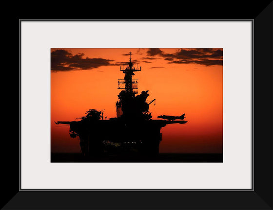 "The setting sun silhouettes the amphibious assault ship USS Makin Island", Gunnery Sgt. Scott Dunn