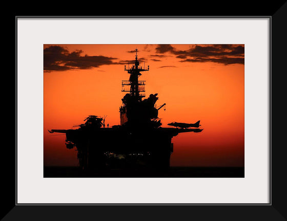 "The setting sun silhouettes the amphibious assault ship USS Makin Island", Gunnery Sgt. Scott Dunn