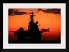 "The setting sun silhouettes the amphibious assault ship USS Makin Island", Gunnery Sgt. Scott Dunn