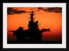 "The setting sun silhouettes the amphibious assault ship USS Makin Island", Gunnery Sgt. Scott Dunn