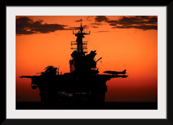 "The setting sun silhouettes the amphibious assault ship USS Makin Island", Gunnery Sgt. Scott Dunn