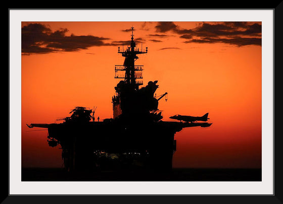 "The setting sun silhouettes the amphibious assault ship USS Makin Island", Gunnery Sgt. Scott Dunn