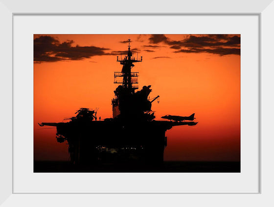 "The setting sun silhouettes the amphibious assault ship USS Makin Island", Gunnery Sgt. Scott Dunn