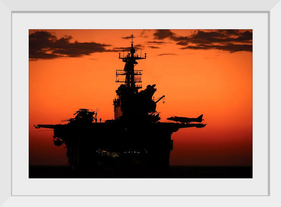 "The setting sun silhouettes the amphibious assault ship USS Makin Island", Gunnery Sgt. Scott Dunn