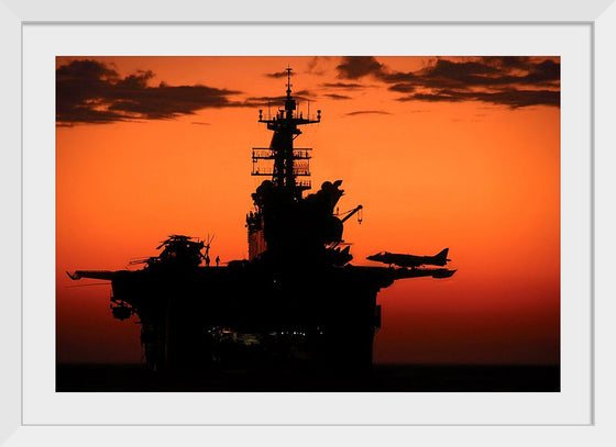 "The setting sun silhouettes the amphibious assault ship USS Makin Island", Gunnery Sgt. Scott Dunn