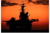 "The setting sun silhouettes the amphibious assault ship USS Makin Island", Gunnery Sgt. Scott Dunn