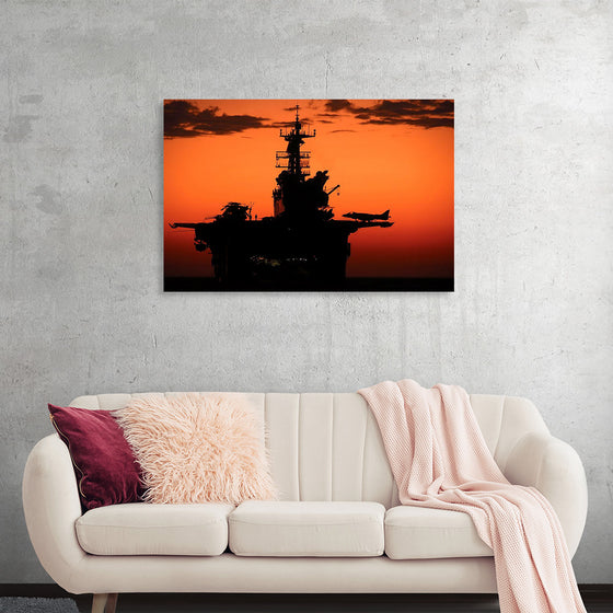 "The setting sun silhouettes the amphibious assault ship USS Makin Island", Gunnery Sgt. Scott Dunn