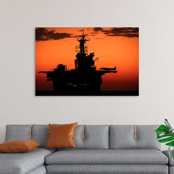 "The setting sun silhouettes the amphibious assault ship USS Makin Island", Gunnery Sgt. Scott Dunn