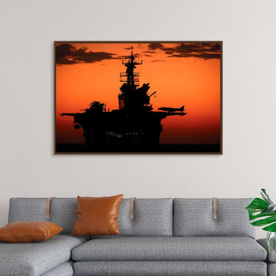 "The setting sun silhouettes the amphibious assault ship USS Makin Island", Gunnery Sgt. Scott Dunn