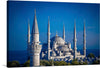 Immerse yourself in the grandeur and elegance of this exquisite print capturing the iconic architecture of a majestic mosque. Each minaret and dome is rendered with meticulous detail, offering a glimpse into the intricate designs that have stood as a testament to architectural mastery for centuries. The serene blue sky and distant horizon provide a tranquil backdrop, inviting viewers to step into a world where art, culture, and history converge. 