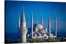  Immerse yourself in the grandeur and elegance of this exquisite print capturing the iconic architecture of a majestic mosque. Each minaret and dome is rendered with meticulous detail, offering a glimpse into the intricate designs that have stood as a testament to architectural mastery for centuries. The serene blue sky and distant horizon provide a tranquil backdrop, inviting viewers to step into a world where art, culture, and history converge. 