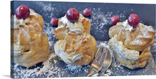  This close-up photo captures the essence of a pastry chef's delight. Three cream puffs, each a different size and shade of golden brown, sit next to each other. Each is crowned with a dollop of whipped cream, like frosting on a cupcake, and a bright red cherry on top. The contrast between the delicate cream puffs and the vibrant cherries is striking.