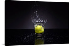  Experience the dynamic energy encapsulated in this stunning print. It captures a moment of explosive vitality as a lemon plunges into a glass of liquid, sending an exuberant spray of droplets dancing into the air. The stark contrast between the vibrant yellow hue of the lemon and the liquid against the deep, dark backdrop adds an element of dramatic intensity. 