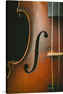  Immerse yourself in the soul-stirring elegance of this exquisite art print, capturing the intimate details of a timeless violin. Every grain, curve, and string is a testament to the meticulous craftsmanship and enduring beauty of this beloved instrument. This piece invites viewers into a world where art and music dance in perfect harmony, offering a visual symphony that enriches any space with an air of sophistication and grace.