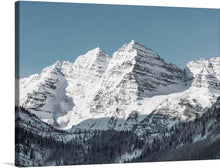  This exquisite print captures the serene beauty of majestic peaks cloaked in pristine snow, standing tall against a tranquil blue sky. The artwork renders every intricate detail, from the rugged textures of the mountains to the delicate interplay of light and shadow, with stunning clarity. It’s more than a visual treat; it’s an experience. It invites viewers into a world where nature’s grandeur and tranquility coexist.