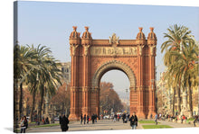  This captivating print features the iconic Arc de Triomf in Barcelona, a testament to architectural elegance and historical significance. The monument’s rich terracotta hues, bathed in the soft glow of sunlight, offer a mesmerizing contrast against the clear blue sky. The scene is brought to life with leisurely strolling pedestrians, adding a touch of everyday serenity. 